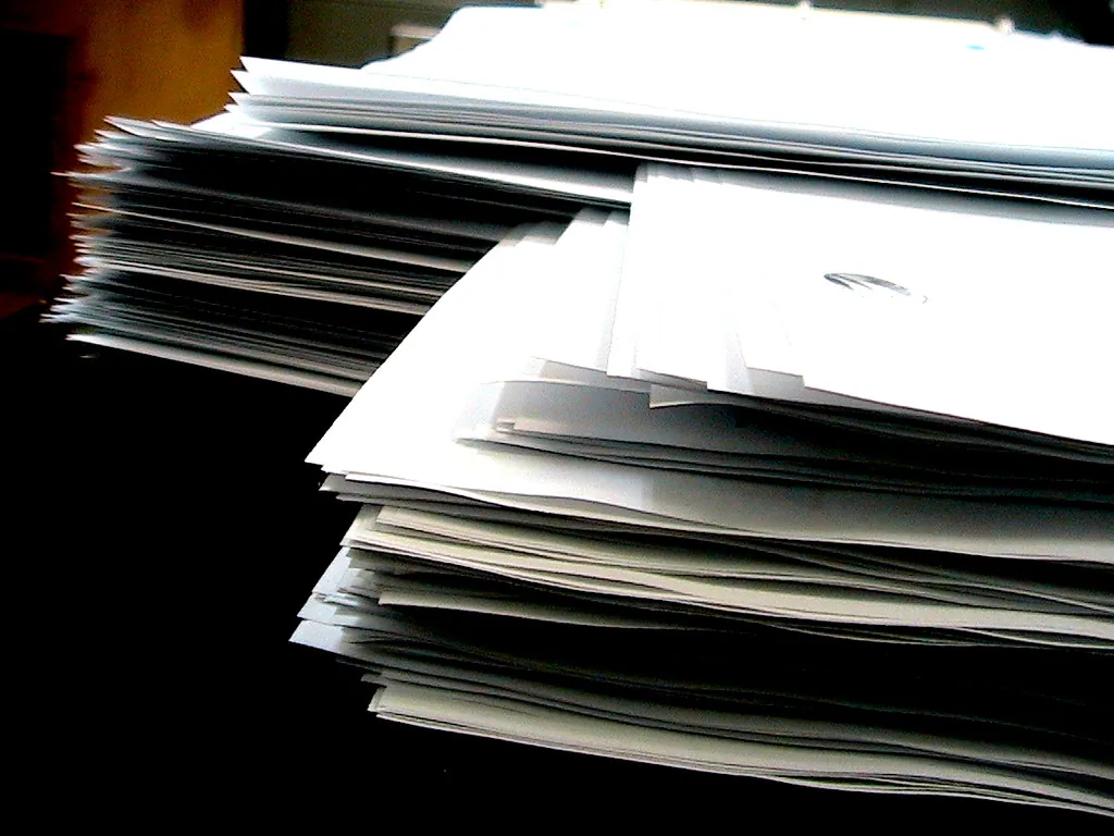 Two stacks of paper with their sheets interleaved in alternating layers.